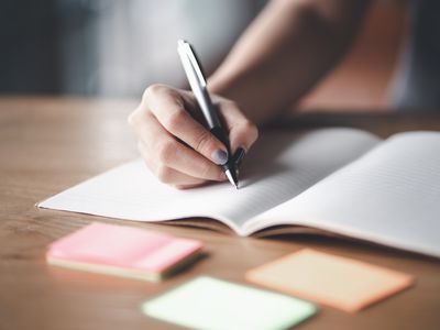 Business woman working at office with documents on his desk, Business woman holding pens and papers making notes in documents on the table, Hands of financial manager taking notes