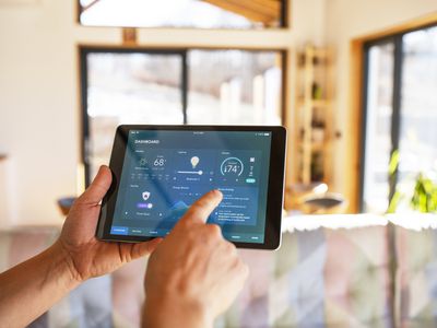 Person using tablet with smart home control functions at home