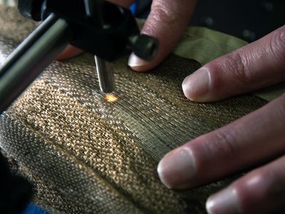 Brian Iezzi scans and measures the photonic fibers in the fabric he developed.