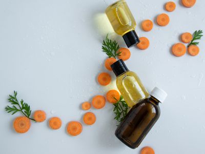 Carrot slices with small bottles of carrot oil