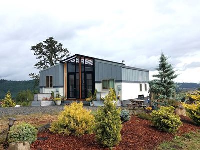 View of two tiny homes connected by a sunroom