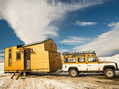 jeep pulling tiny house through desert and big open sky