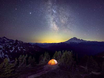 A tent is under the Milky Way on the top of a mountain, Washington, US