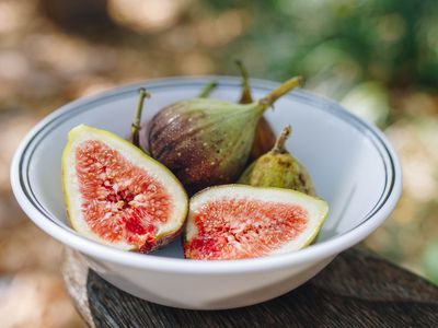 white bowl of cut figs