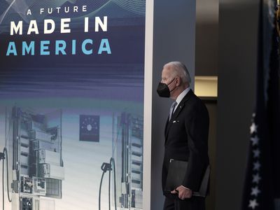 Biden standing near a sign