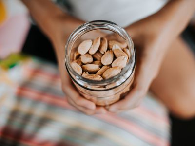 boy holding jar full of organic almonds.Selective focus