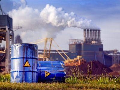 chemical waste drums in front of heavy industry