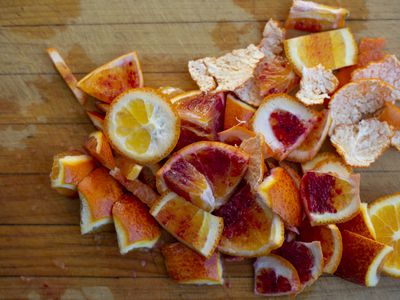 pile of orange peels on a wooden board