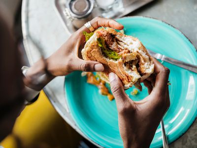 Close Up of Woman Eating Vegan Meal