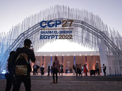 Attendees photograph one another outside the main entrance on the first day of the UNFCCC COP 27 climate conference on November 06, 2022 in Sharm El Sheikh, Egypt. 