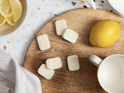 A cutting board with dishwasher tablets