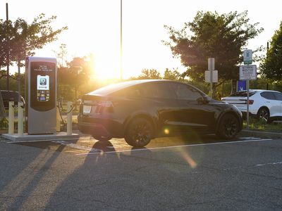 car in a parking lot getting charged 