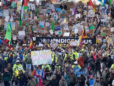 Demonstrators walk through the city during the Fridays For Future march on November 5, 2021 in Glasgow, Scotland.