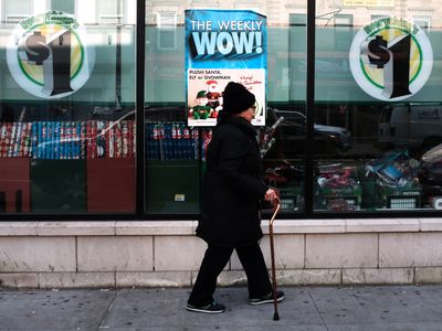 Woman walking past dollar store.