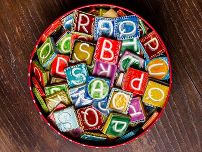 Bucket of colorful ceramic letter tiles