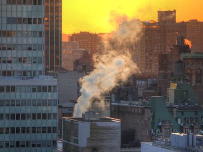 High Angle View Of Buildings In City At Sunset