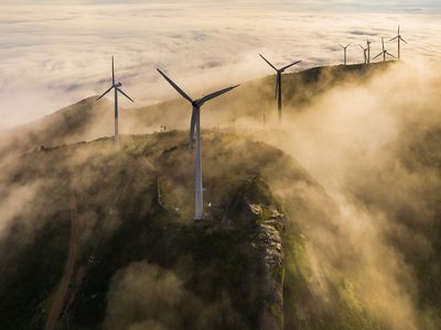 Wind turbines located on mountain ridges in the mist