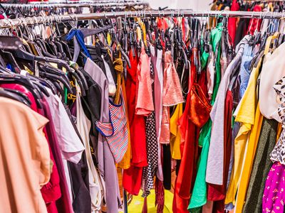 Colorful garments placed tightly together on a circular rack