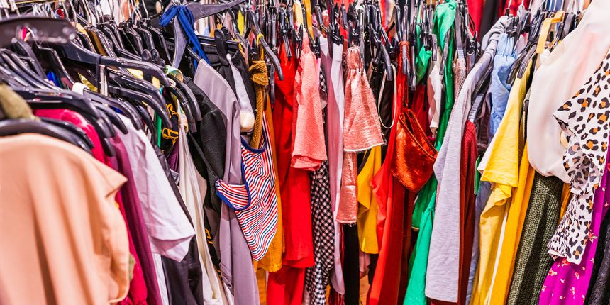 Colorful garments placed tightly together on a circular rack