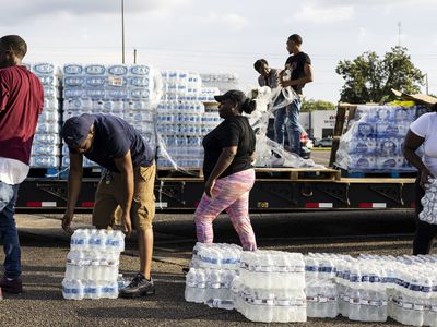 Cases of bottled water are handed out at a Mississippi Rapid Response Coalition distribution site on August 31, 2022 in Jackson, Mississippi. 