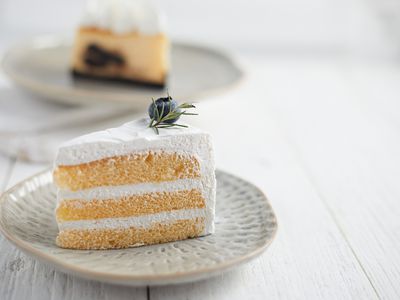 a slice of vanilla cake against a rustic white background