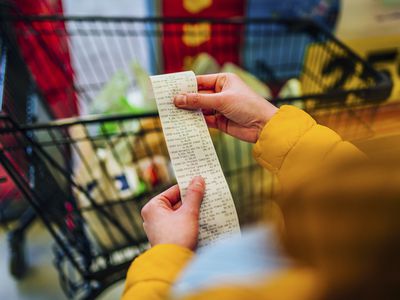 Woman checking the bill when paying at a supermarket