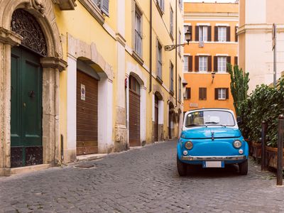 Small car in front of multifamily housing