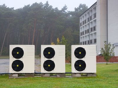 Air source heat pumps in front of an apartment building