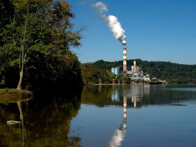 An emissions plume rises from the Mitchell Power Station, a coal-fired power plant, with the Monongahela River in foreground.