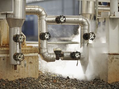 steam being released from pipes in an industrial setting