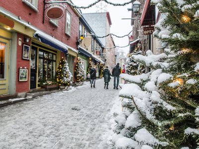 a snowy small town street for shopping with holiday decorations