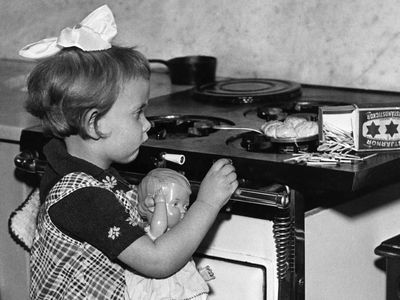 Child lighting a gas stove