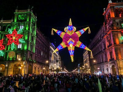 Mexico City at night during Christmas with giant lit piÃ±ata