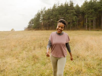 Happy woman takes a walk in nature