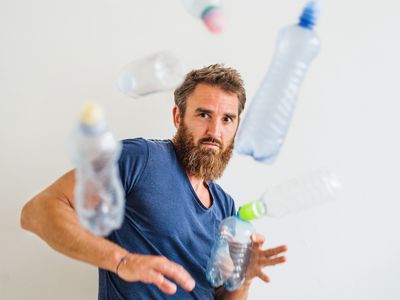 Man avoiding water bottles flying at him.