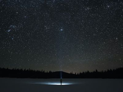 man looking up at night sky