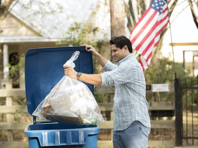 man puts out recycling