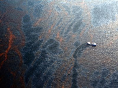 A boat works to collect oil that has leaked from the Deepwater Horizon wellhead in the Gulf of Mexico on April 28, 2010 near New Orleans, Louisiana. 