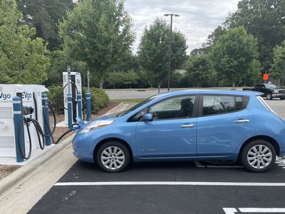 Side view of a blue Nissan Leaf