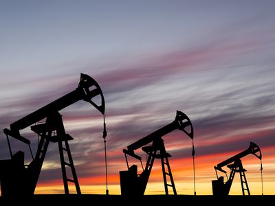 Oil pump on a sunset background. World Oil Industry