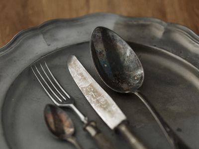 Old metal scalloped tray with eating utensils