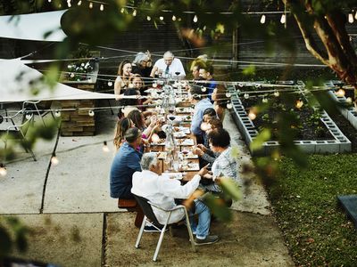 Overhead view of family seated together on outdoor patio for celebration dinner