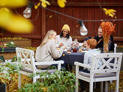 Smiling family and friends sitting at table for social gathering