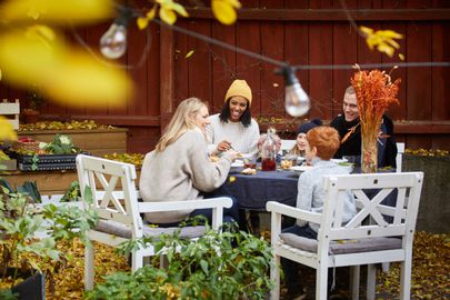 Smiling family and friends sitting at table for social gathering