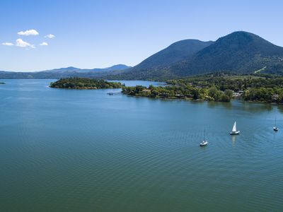 The aerial low-altitude scenic view of the Buckingham Park on the Clear Lake, California, with yachts on a moorage. The sunny spring day.