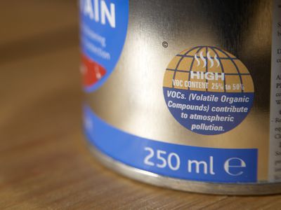 Tin of paint with sticker showing high percentage of VOC (Volatile Organic Compounds) contributing to atmospheric pollution