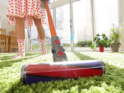 Woman Vacuuming Rug