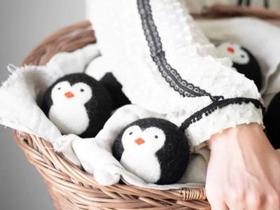 Penguin dryer balls in a basket of alundry