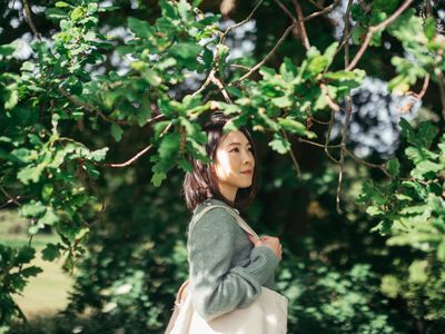 Young Woman Looking At View While Walking In The Park