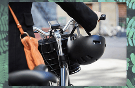 The back of a rider with their hands on the bars of an e-bike